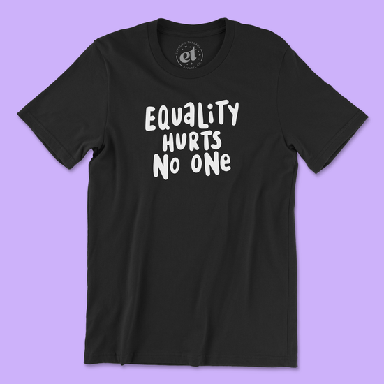 Black unisex 100% cotton LGBTQ pride tee with white text that says “Equality Hurts No One” in a bold, hand-lettered font. Background is light purple.